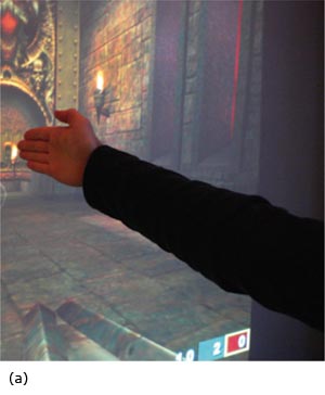 Gestures for controlling Q3A. (a) Using a “vertical” hand to control the player's aim. (b) Controlling aim and firing by making the hand flat. (c) Moving and aiming simultaneously using both hands.