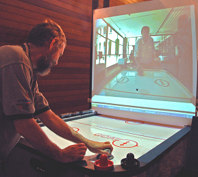 Airhockey over a Distance