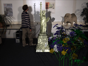 Final mixing result with shadow mapping. In this example two light sources are placed left and right of the camera. The real light sources have been simulated in the shadow mapping and shadow casting between virtual content and real dynamic content is visible. (Note the shadow on the legs of the person.)